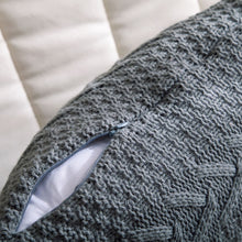 close up showing zipper for solid knitted throw pillow cover